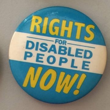 Photo of a badge with the slogan Rights For Disabled People Now