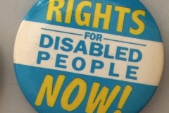 Photo of a badge with the slogan Rights For Disabled People Now