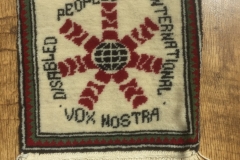 Photo of a tapestry with the words Disabled Peoples' International