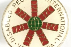 Photo of a badge with the words Disabled People's International