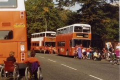 Photo: disabled people blocking the road in front of 2 buses, Wilmslow Road Manchester, 1992